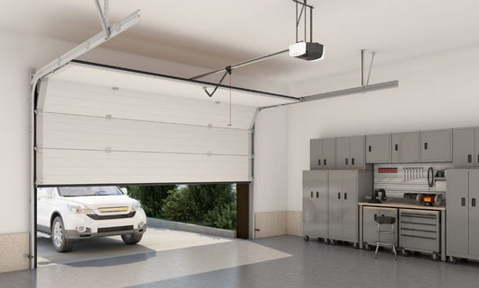 Genie garage door opener installed in a garage with the door opener and car outside