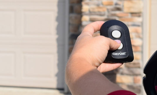 2 button universal garage door opener remote with finger pressing button to operate