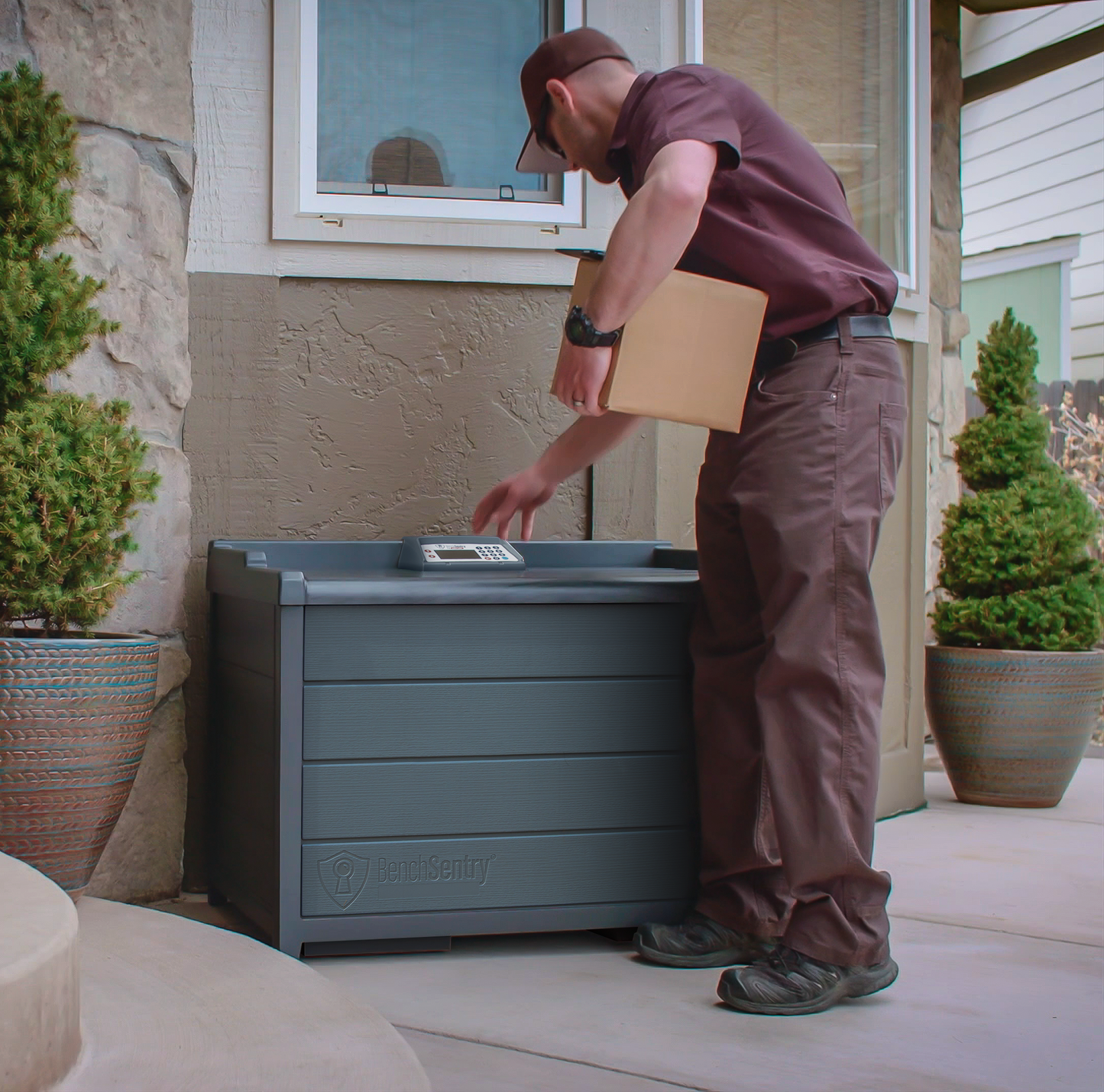 Delivery Driver placing a package into a BenchSentry Connect Package Delivery Box