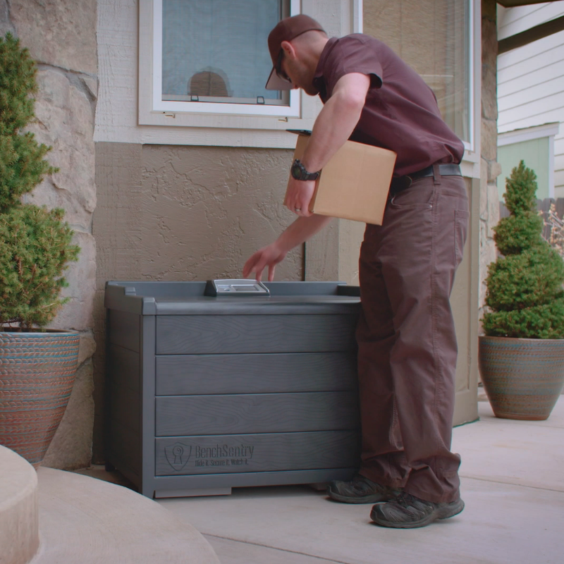 Delivery Person putting package into a BenchSentry Package Lockbox