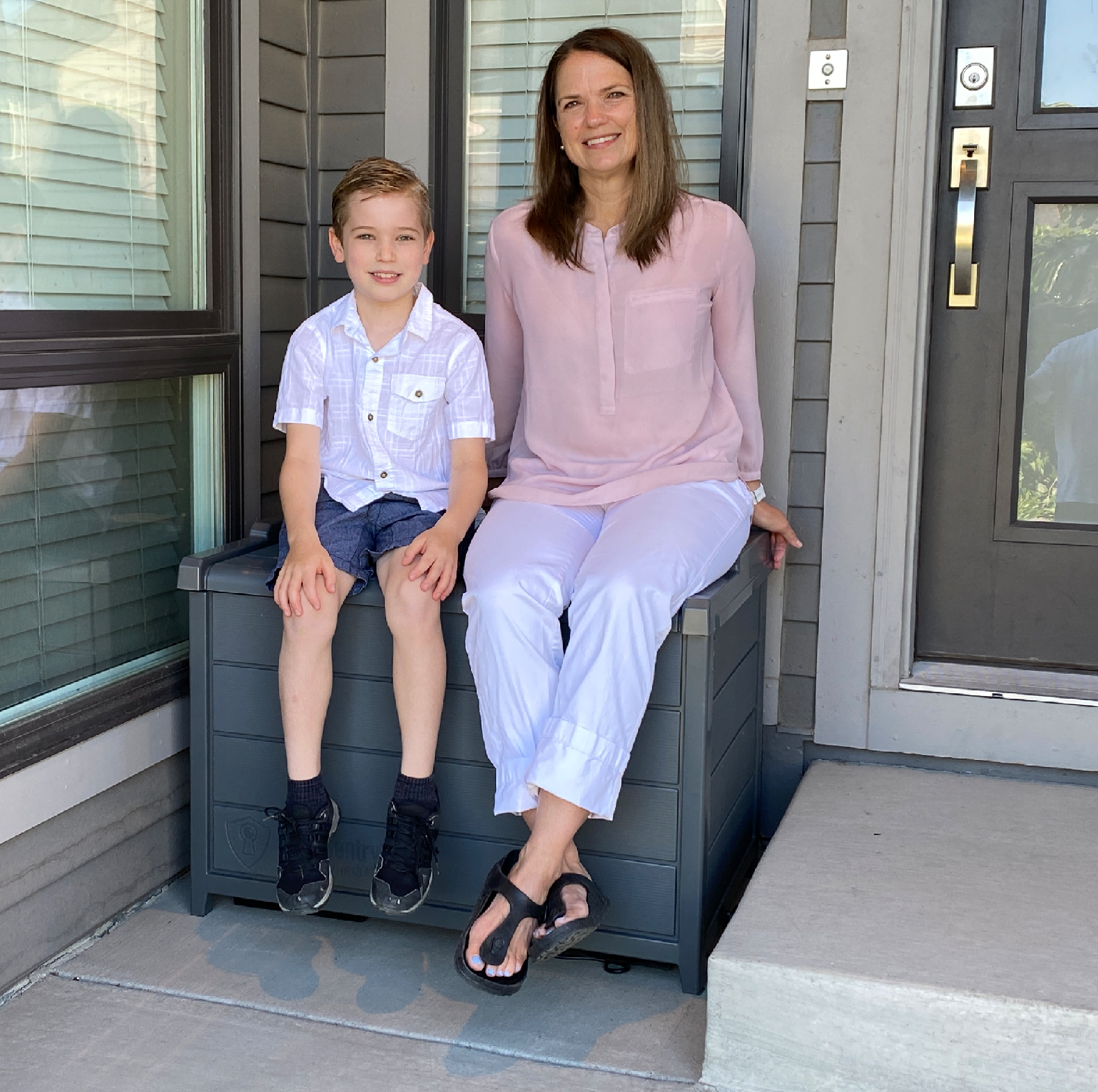 Mother and son sitting on a BenchSentry package delivery box on the porch