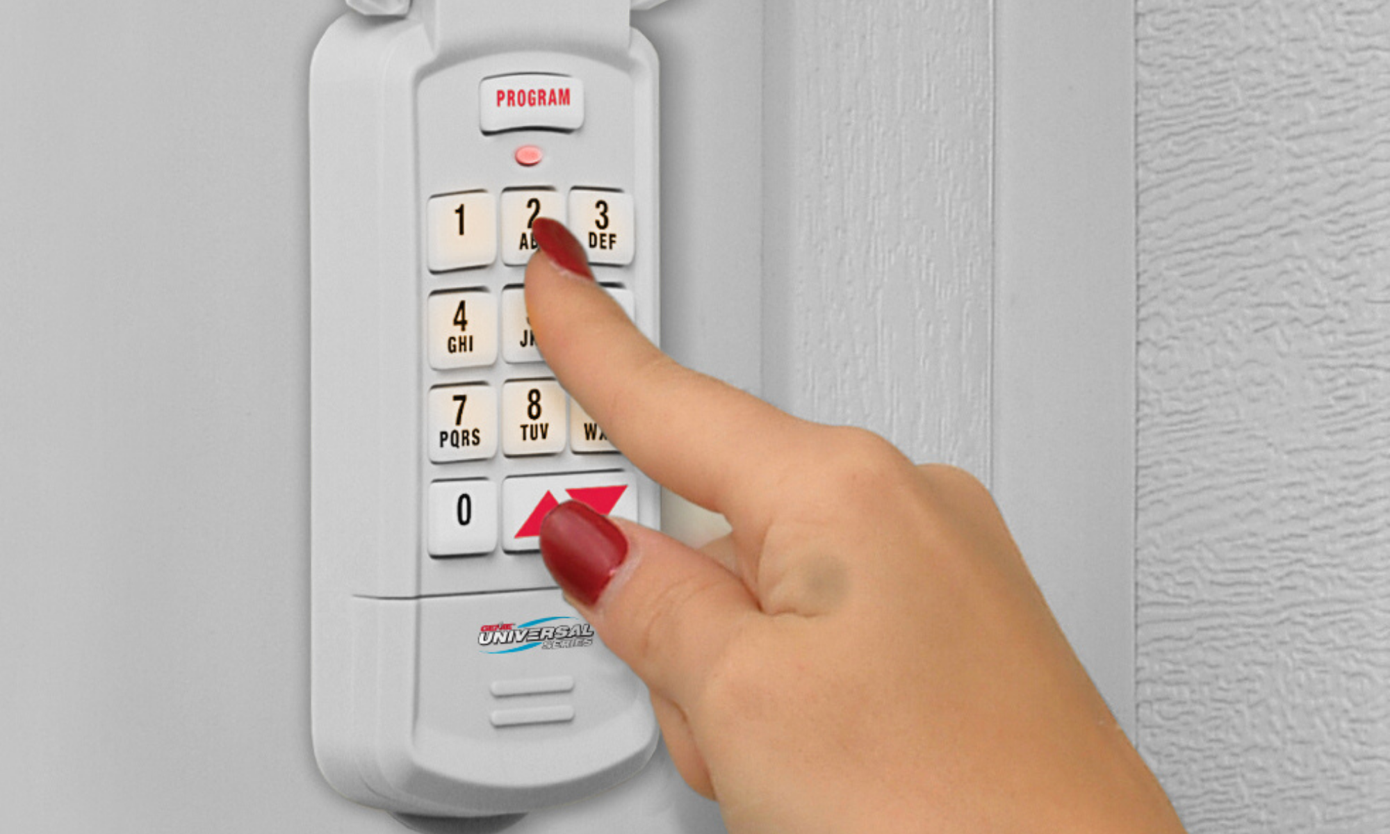 Universal Garage Door Opener Wireless Keypad hangs outside the garage door