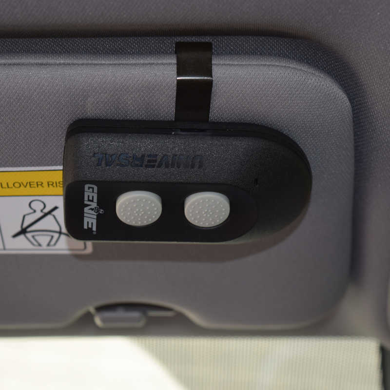 Universal Garage Door Opener Remote installed on a car visor